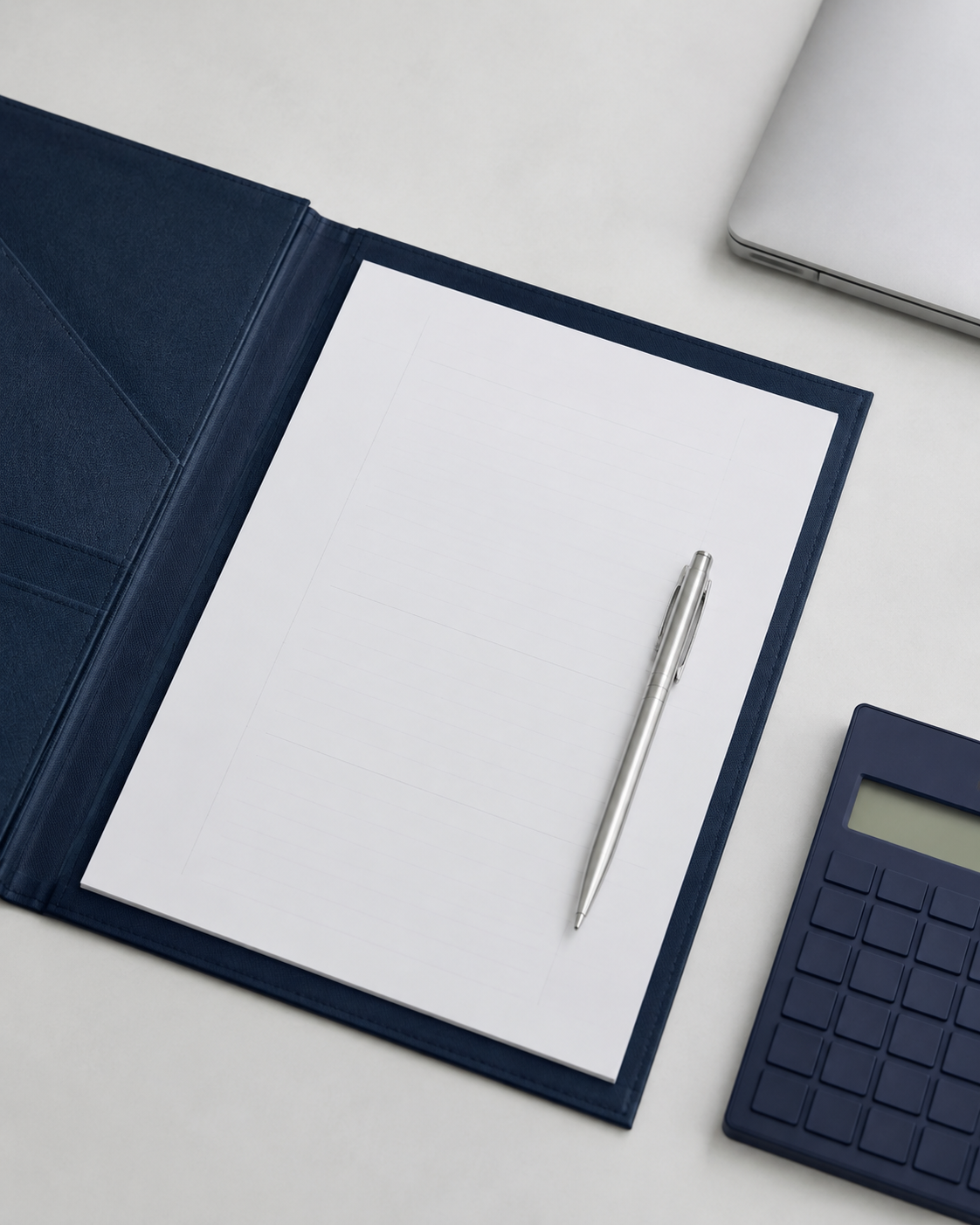Navy and silver business planning materials arranged on a clean workspace